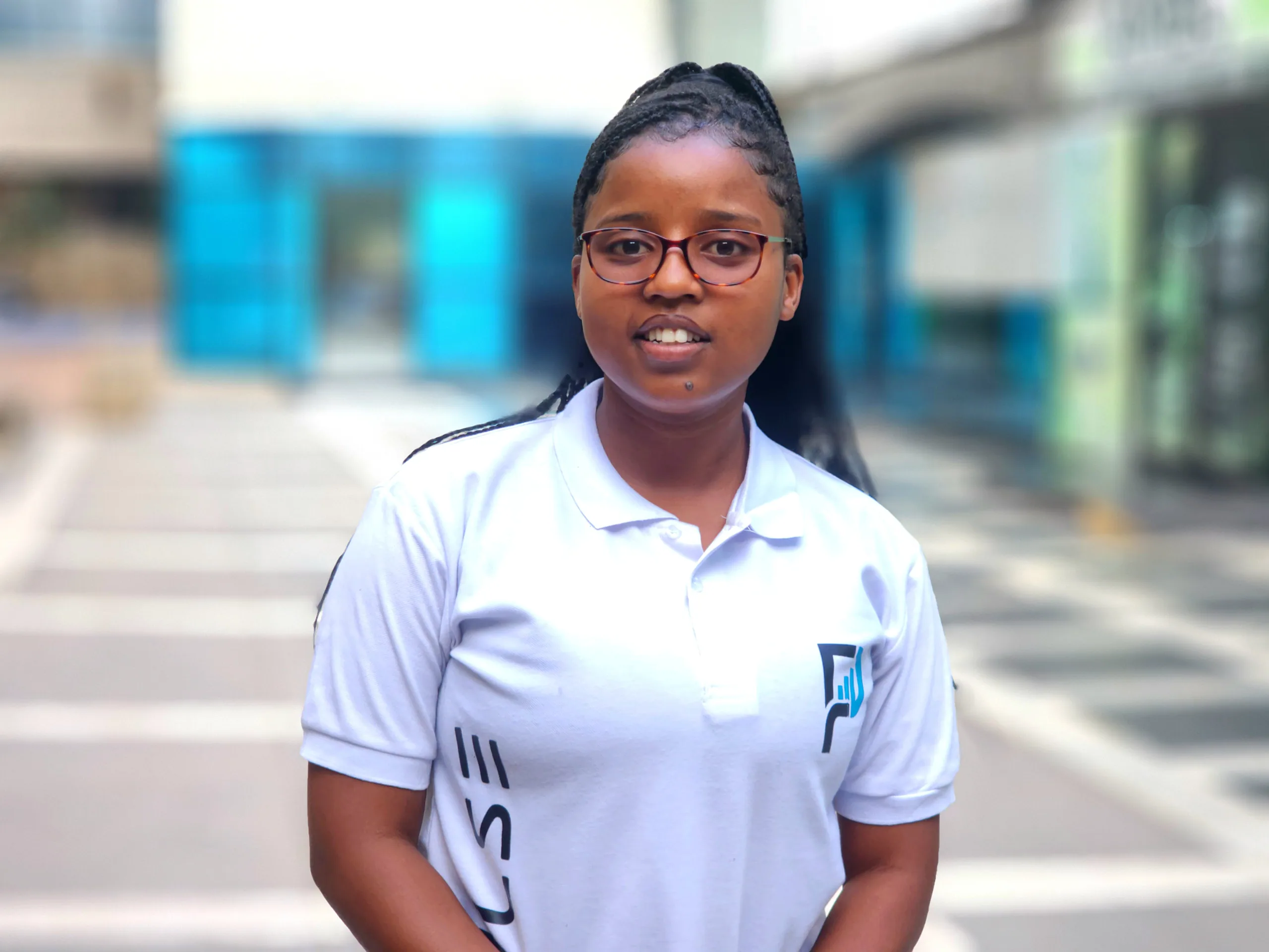 A PULSE team member in a branded polo shirt on a street in central Harare