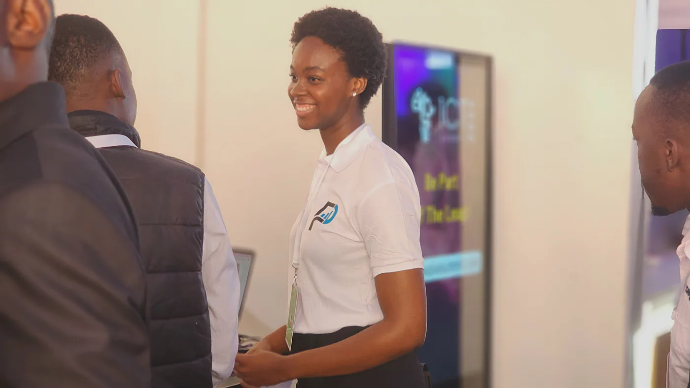 A PULSE team member talking with employers at an ICT expo stand