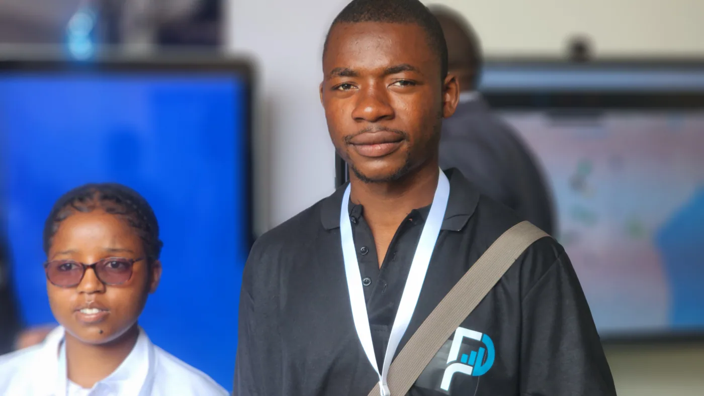 A young PULSE team member in branded uniform at a technology event